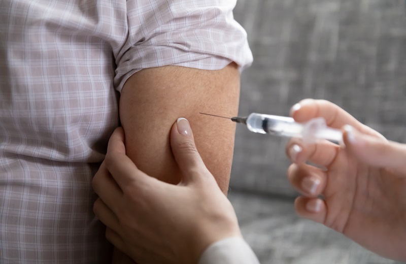 Ein Mensch wird von einer medizinischen Fachkraft geimpft